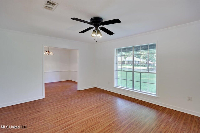 unfurnished room featuring crown molding, hardwood / wood-style flooring, and ceiling fan with notable chandelier