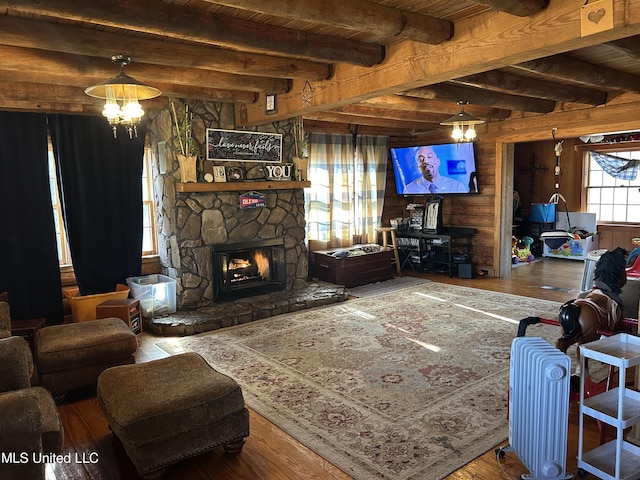 living room featuring a notable chandelier, wood ceiling, beamed ceiling, and a fireplace