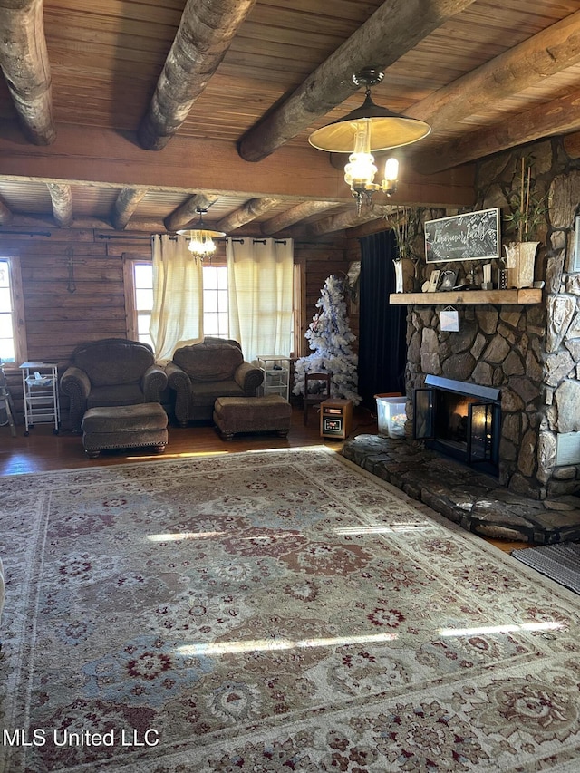 living room featuring log walls, beam ceiling, a fireplace, wooden ceiling, and wood-type flooring