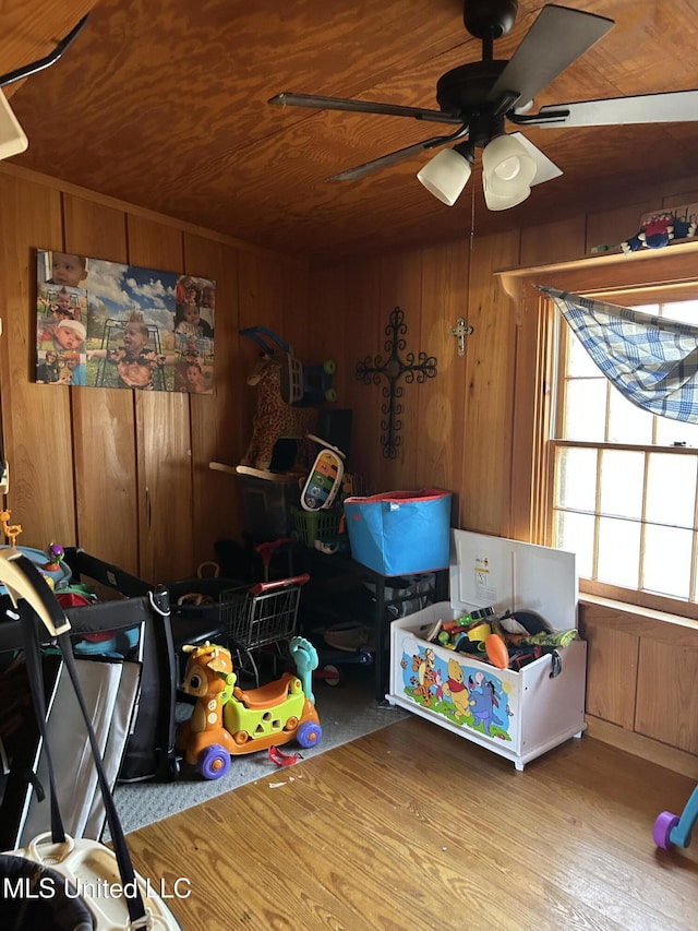 recreation room with wooden walls, ceiling fan, and wood ceiling