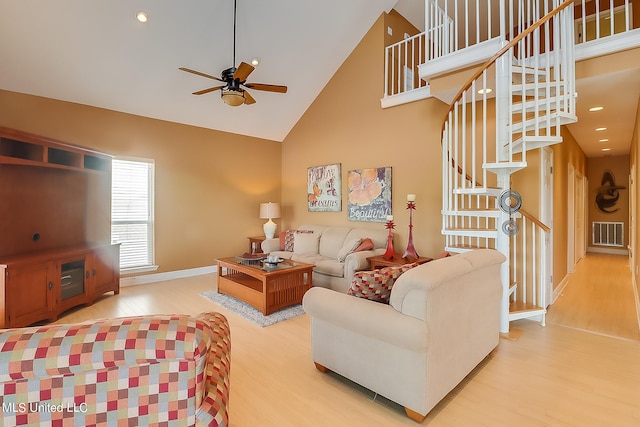 living room featuring hardwood / wood-style floors, high vaulted ceiling, and ceiling fan