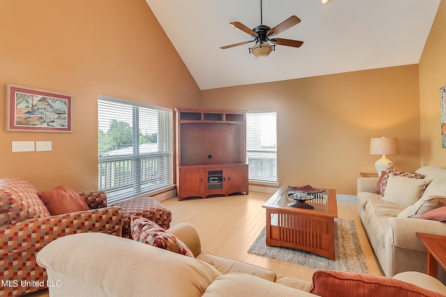 living room with high vaulted ceiling, a healthy amount of sunlight, light wood-type flooring, and ceiling fan