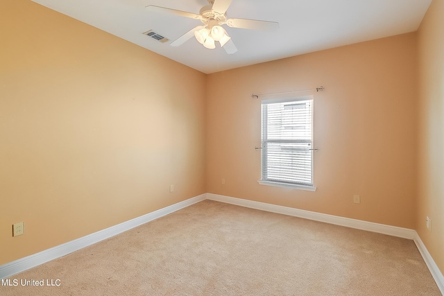 carpeted empty room featuring ceiling fan