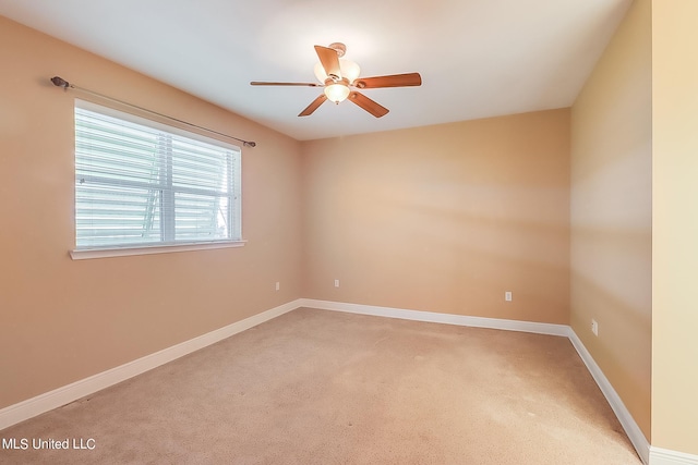 carpeted empty room featuring ceiling fan