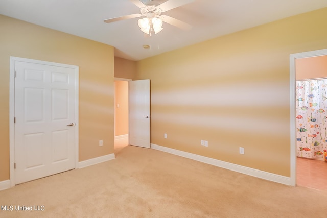 unfurnished bedroom featuring light colored carpet and ceiling fan