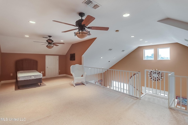 carpeted bedroom with ceiling fan and vaulted ceiling