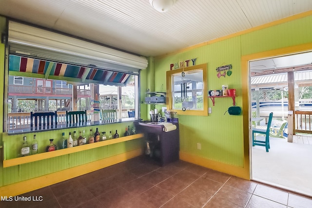 interior space with indoor bar and tile patterned floors