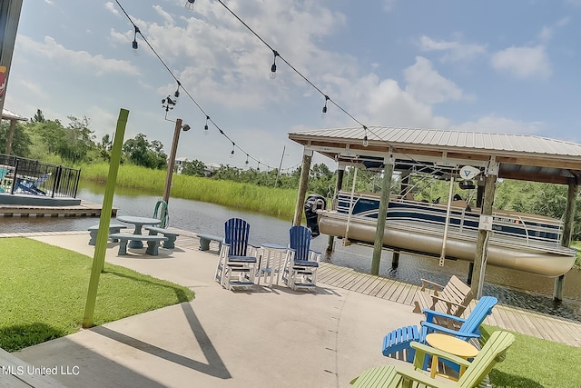 view of dock with a patio area, a yard, and a water view