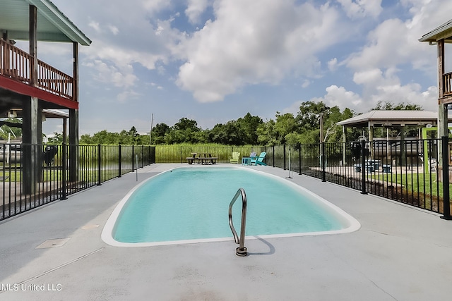 view of swimming pool with a water view and a gazebo