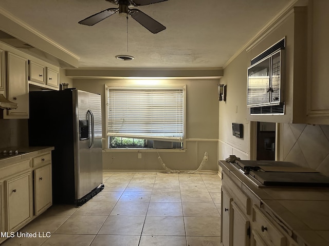 25 Oak Creek Pl, Jackson, MS 39211 - kitchen with stainless steel fridge, a ceiling fan, ornamental molding, black microwave, and light tile patterned floors
