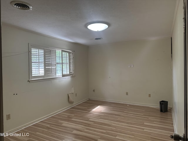 25 Oak Creek Pl, Jackson, MS 39211 - spare room featuring light wood-style floors, a textured ceiling, and ornamental molding