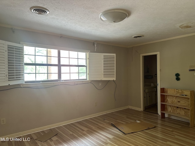 25 Oak Creek Pl, Jackson, MS 39211 - unfurnished bedroom with a textured ceiling, ornamental molding, and wood finished floors