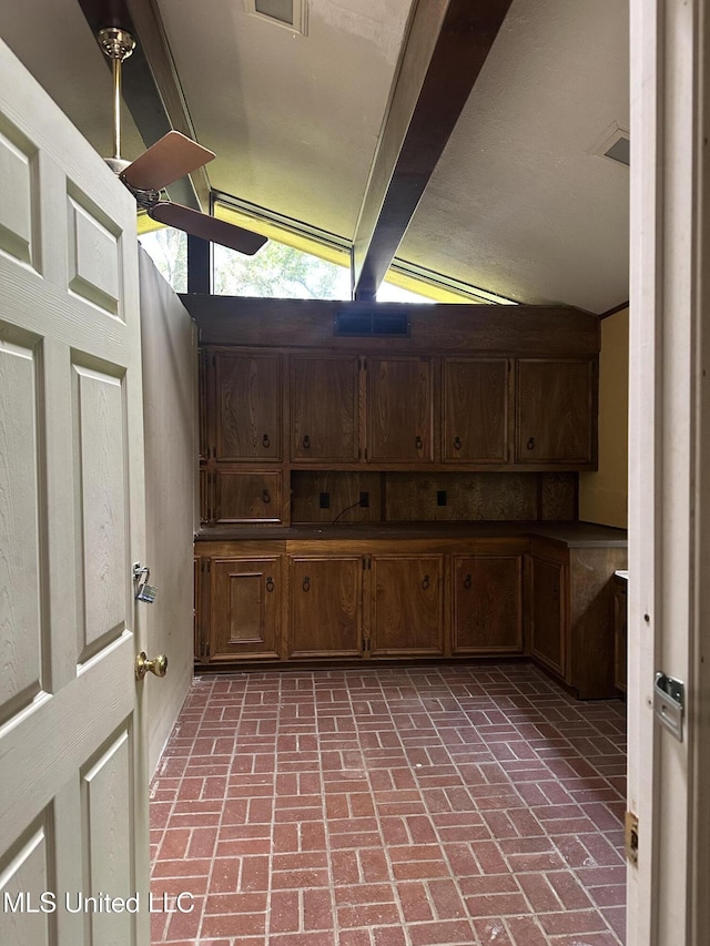 25 Oak Creek Pl, Jackson, MS 39211 - kitchen featuring beam ceiling, brick flooring, and dark countertops