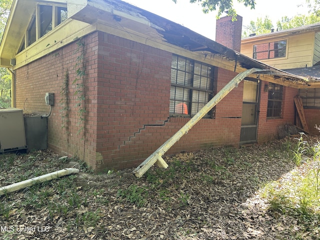 25 Oak Creek Pl, Jackson, MS 39211 - view of side of home featuring brick siding and a chimney