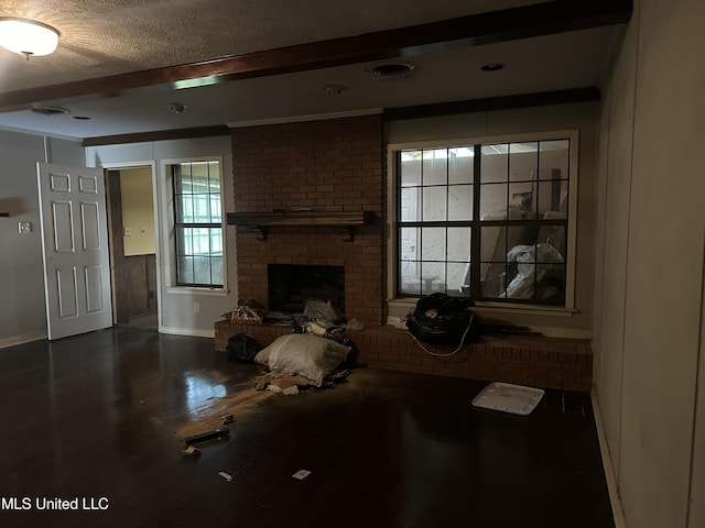 25 Oak Creek Pl, Jackson, MS 39211 - living room featuring beam ceiling, wood finished floors, a textured ceiling, and a brick fireplace
