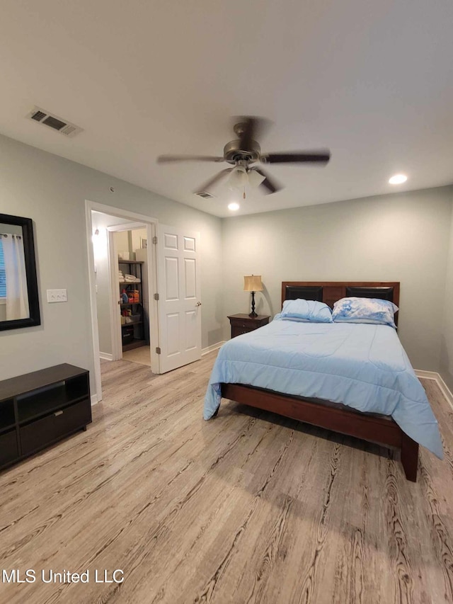 bedroom with light wood finished floors, visible vents, baseboards, and recessed lighting