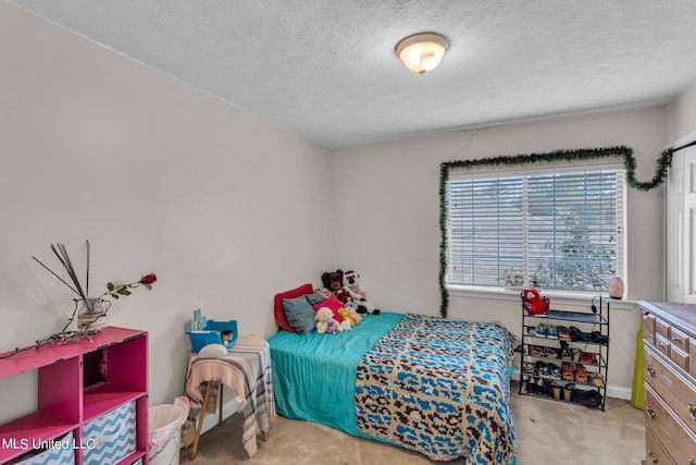 carpeted bedroom featuring a textured ceiling