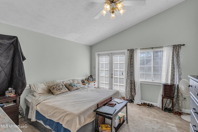 bedroom featuring lofted ceiling, light carpet, a textured ceiling, and ceiling fan