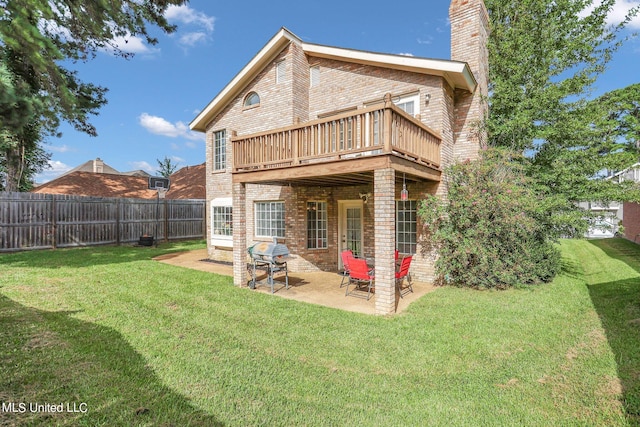 back of property featuring a patio area and a lawn