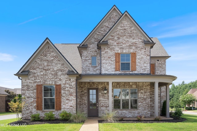8025 Old Addison Dr, Olive Branch, MS 38654 - view of front of house with brick siding, a shingled roof, and a porch