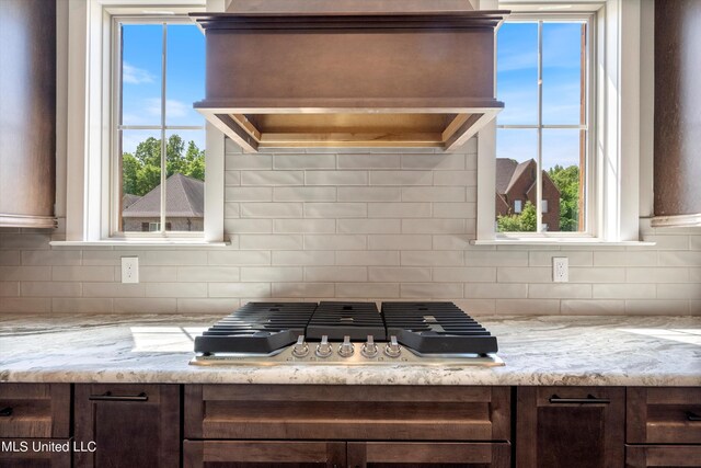 8025 Old Addison Dr, Olive Branch, MS 38654 - kitchen featuring stainless steel gas cooktop, dark brown cabinets, and tasteful backsplash