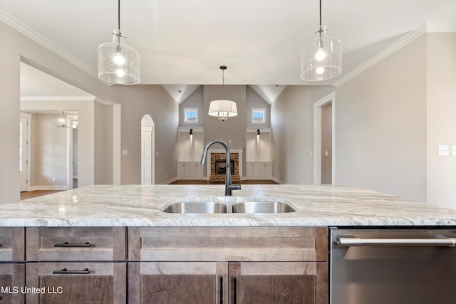 8025 Old Addison Dr, Olive Branch, MS 38654 - kitchen featuring stainless steel dishwasher, a sink, arched walkways, light stone counters, and crown molding