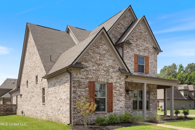 8025 Old Addison Dr, Olive Branch, MS 38654 - view of front of house with brick siding, a shingled roof, and a front lawn