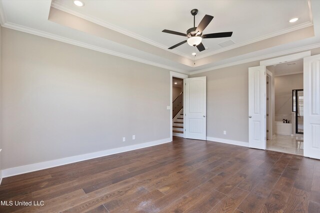 8025 Old Addison Dr, Olive Branch, MS 38654 - unfurnished bedroom featuring a tray ceiling, dark wood finished floors, ornamental molding, baseboards, and recessed lighting