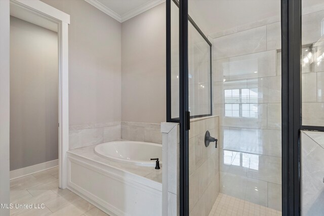8025 Old Addison Dr, Olive Branch, MS 38654 - bathroom featuring a garden tub, a stall shower, ornamental molding, tile patterned floors, and baseboards