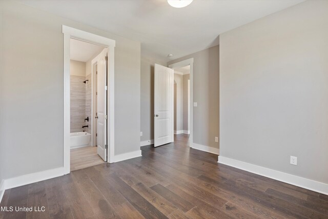 8025 Old Addison Dr, Olive Branch, MS 38654 - spare room with dark wood-type flooring and baseboards