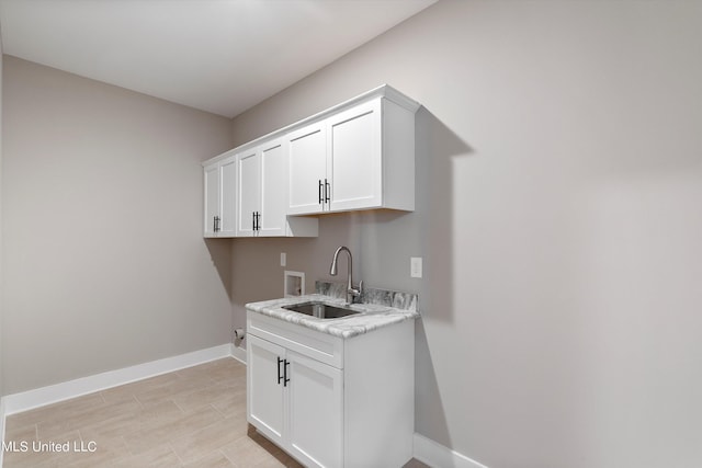 8025 Old Addison Dr, Olive Branch, MS 38654 - laundry room featuring hookup for a washing machine, baseboards, and cabinet space