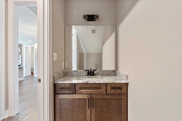 8025 Old Addison Dr, Olive Branch, MS 38654 - bathroom with wood finished floors, vanity, and baseboards
