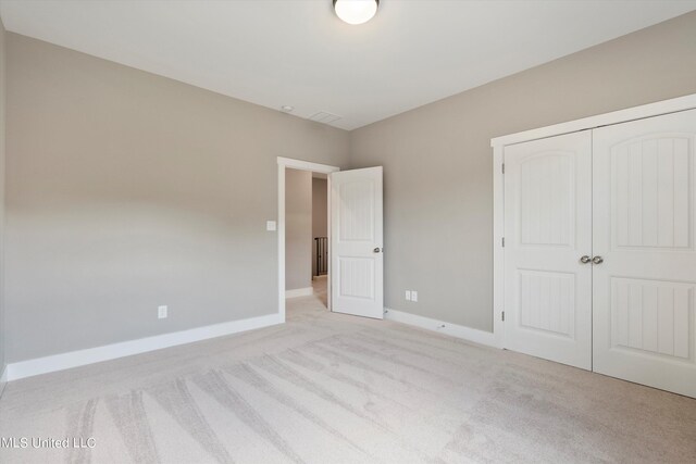 8025 Old Addison Dr, Olive Branch, MS 38654 - unfurnished bedroom featuring light carpet, a closet, and baseboards
