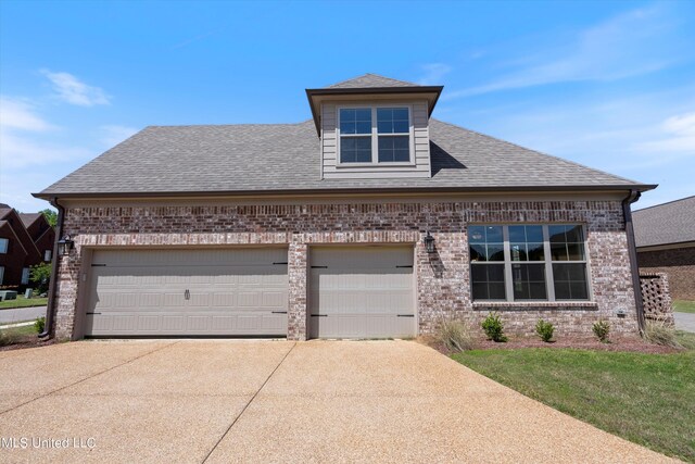 8025 Old Addison Dr, Olive Branch, MS 38654 - view of front of home featuring brick siding, driveway, an attached garage, and roof with shingles