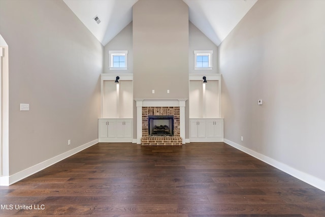8025 Old Addison Dr, Olive Branch, MS 38654 - unfurnished living room featuring high vaulted ceiling, wood finished floors, a brick fireplace, healthy amount of natural light, and baseboards