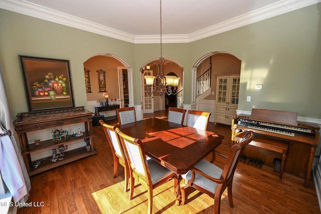 dining room with crown molding, hardwood / wood-style flooring, and a chandelier