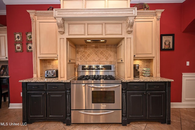 kitchen featuring backsplash, stainless steel range with gas cooktop, light stone countertops, and ornamental molding