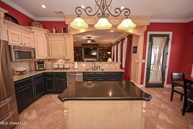 kitchen with stainless steel appliances, a center island, sink, and hanging light fixtures