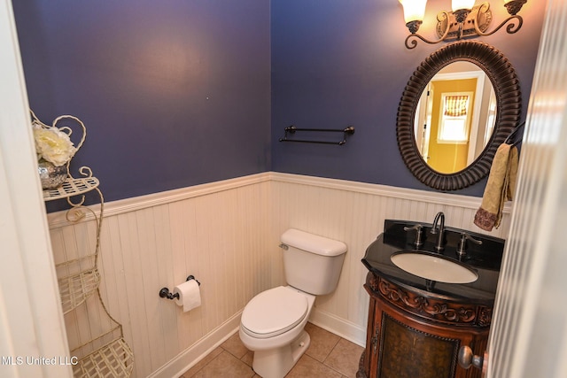 bathroom featuring tile patterned flooring, vanity, and toilet