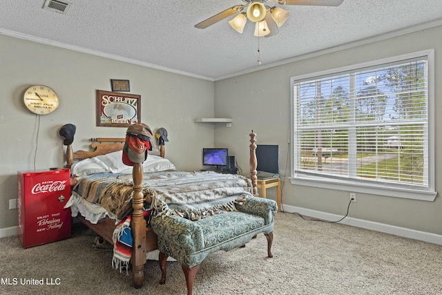 carpeted bedroom featuring a textured ceiling, baseboards, ornamental molding, and visible vents
