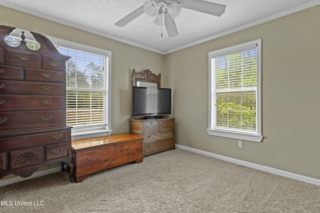 bedroom featuring carpet flooring, a textured ceiling, baseboards, and ornamental molding