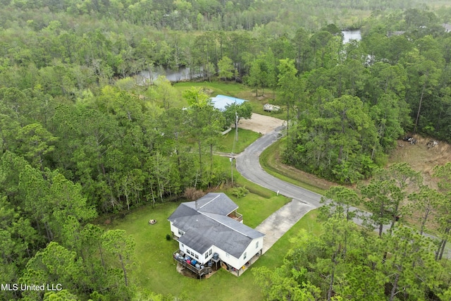 birds eye view of property with a water view and a view of trees