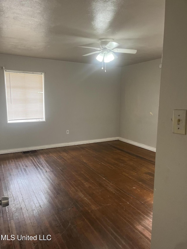 3006 Oak Forest Dr, Jackson, MS 39212 - unfurnished room featuring dark wood-style floors, ceiling fan, a textured ceiling, and baseboards
