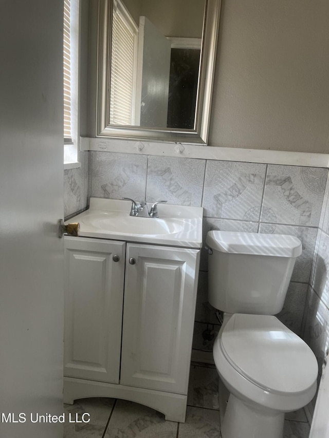 3006 Oak Forest Dr, Jackson, MS 39212 - bathroom featuring tile walls, marble finish floor, vanity, and toilet