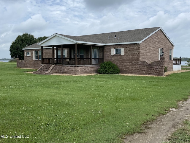 rear view of house with a yard