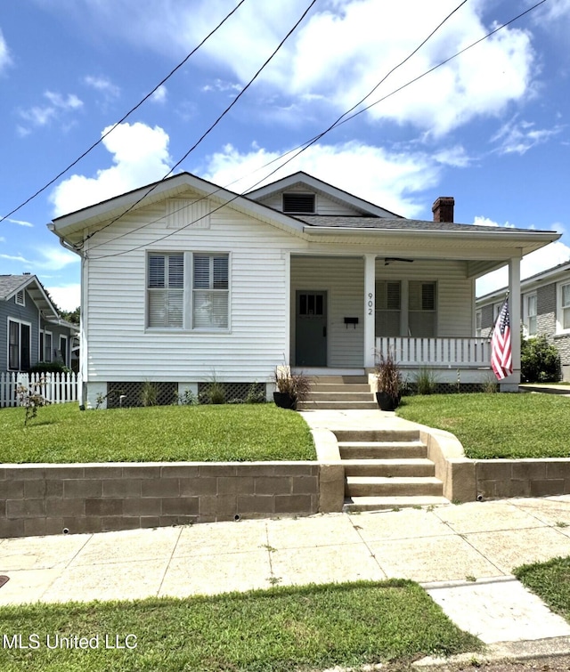 902 Washington St, Natchez, MS 39120 - view of front of property with covered porch, a front yard, and a chimney