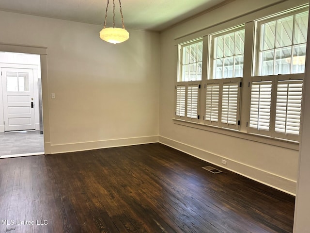 902 Washington St, Natchez, MS 39120 - spare room with baseboards and dark wood finished floors