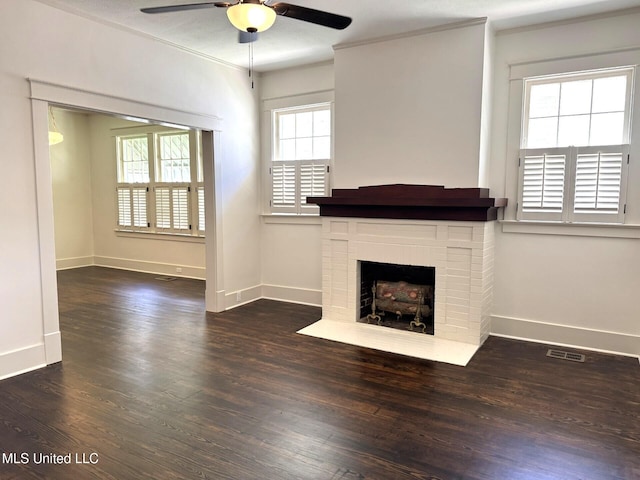 902 Washington St, Natchez, MS 39120 - unfurnished living room featuring a ceiling fan, a brick fireplace, ornamental molding, and wood finished floors