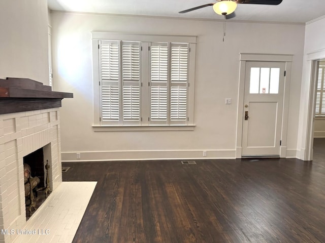 902 Washington St, Natchez, MS 39120 - unfurnished living room featuring ceiling fan, wood finished floors, a brick fireplace, and ornamental molding