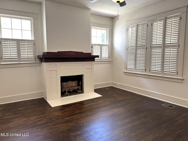 902 Washington St, Natchez, MS 39120 - unfurnished living room with ceiling fan, wood finished floors, and a brick fireplace